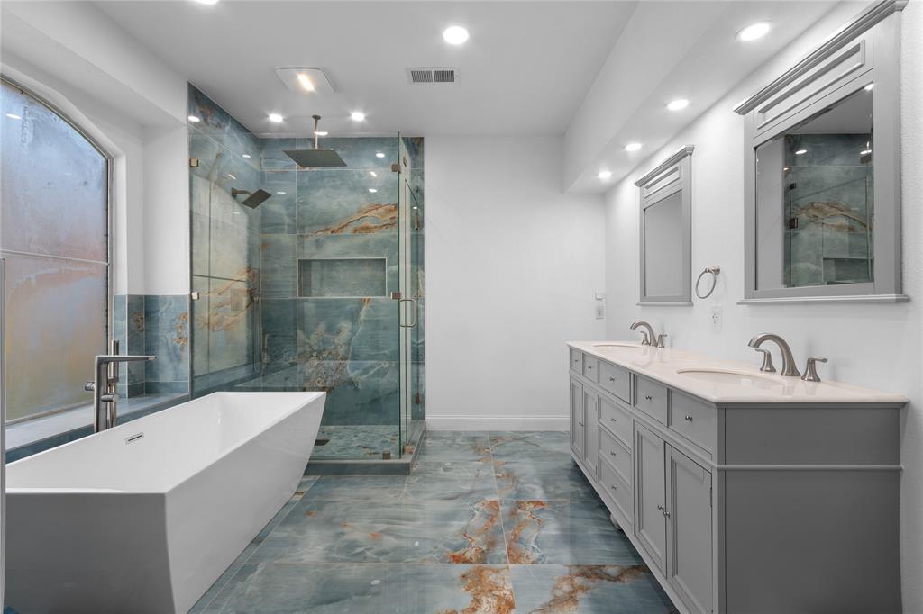 225 Freedom Court Rockwall, TX 75032 - Photo 15 of 28 a bathroom with a double vanity sink mirror and bathtub