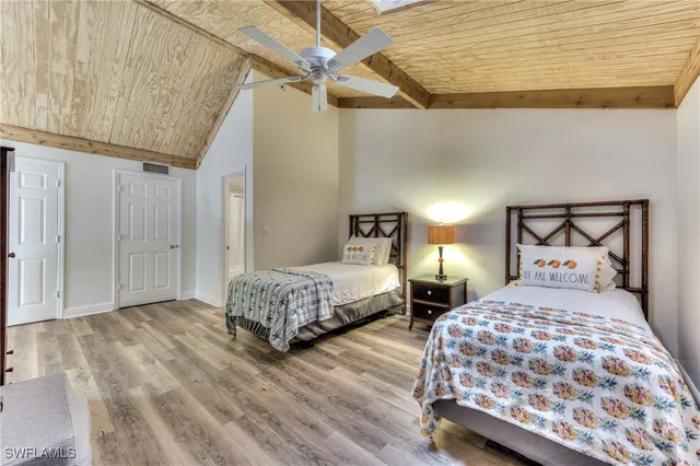 a bedroom with furniture and a wooden floor