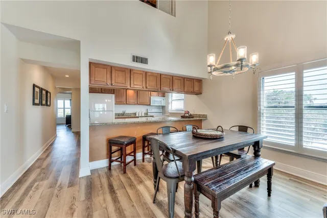 a kitchen with a table chairs stove and cabinets