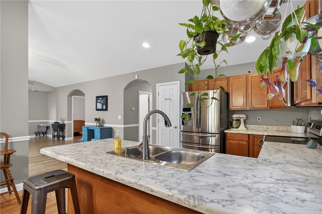 151 Towne Creek Trail Anderson, SC 29621 - Photo 8 of 49 A well-equipped kitchen boasts a double-basin sink and stainless steel refrigerator, perfect for culinary endeavors.