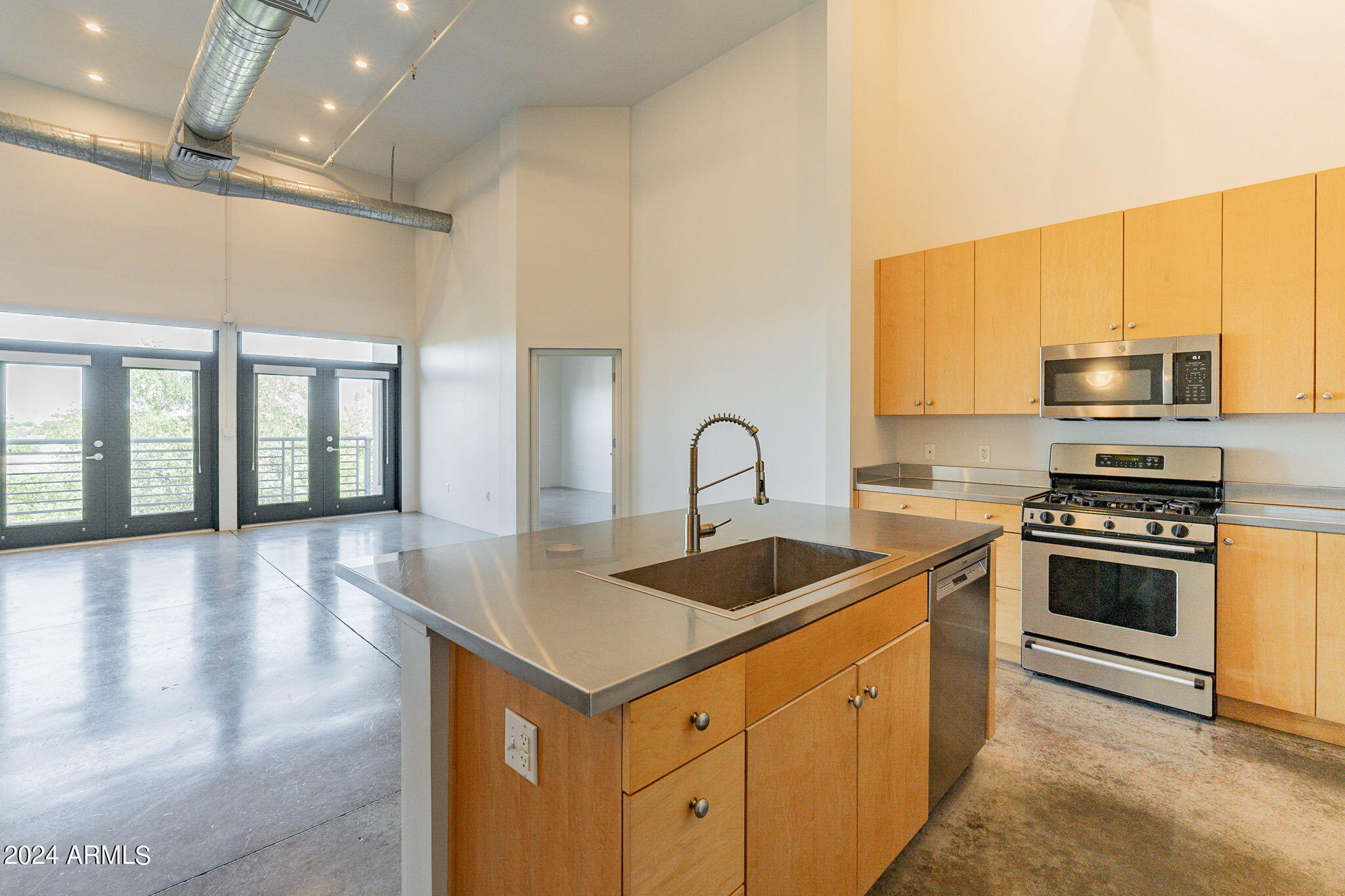 914 East Osborn Road, Unit 416 Phoenix, AZ 85014 - Photo 14 of 44 a kitchen with stainless steel appliances granite countertop a stove a sink and a microwave