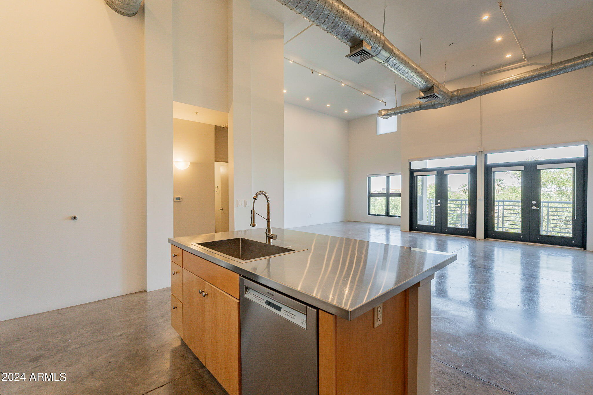 914 East Osborn Road, Unit 416 Phoenix, AZ 85014 - Photo 15 of 44 a kitchen that has a sink and a wooden floor