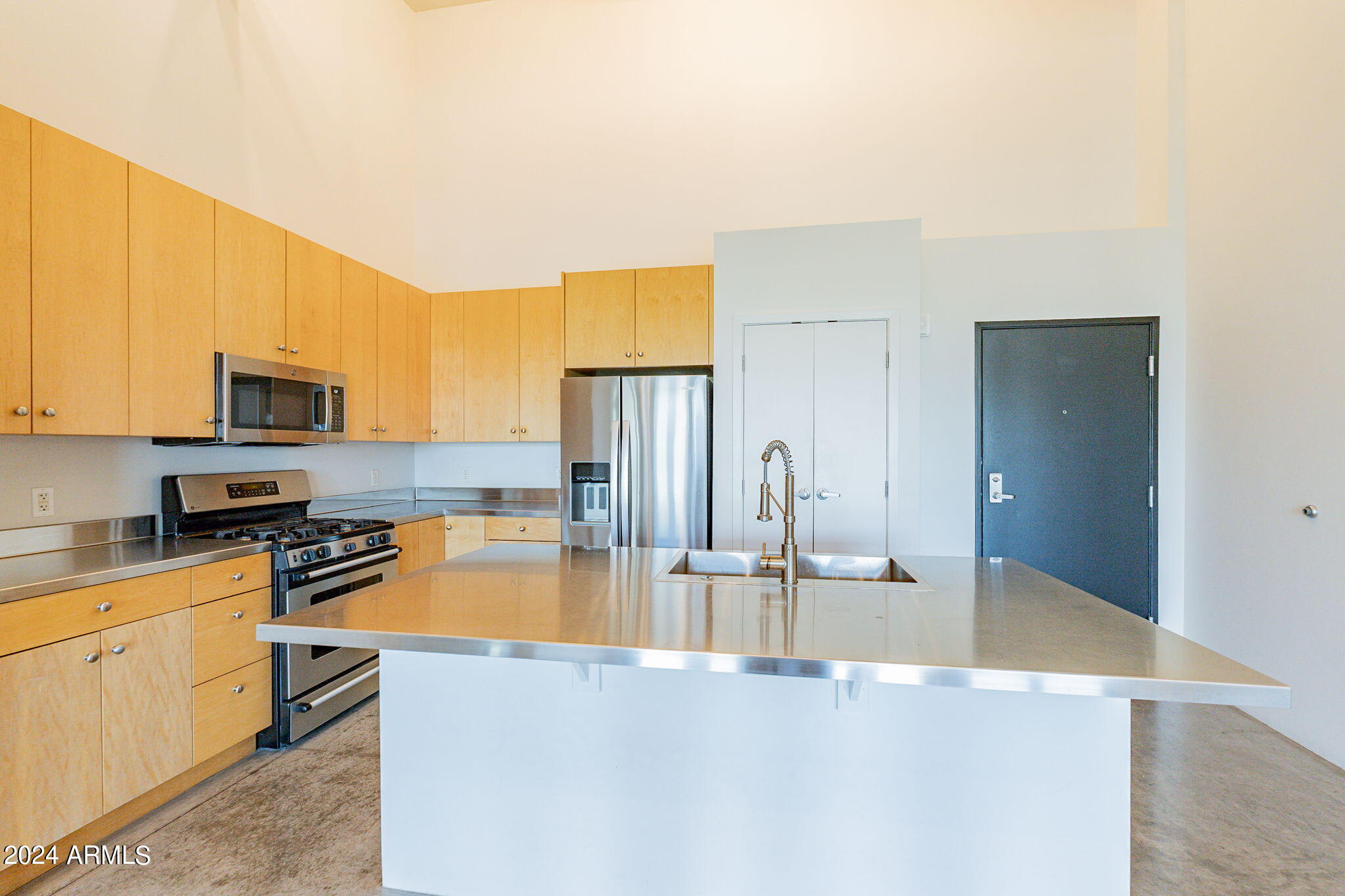 914 East Osborn Road, Unit 416 Phoenix, AZ 85014 - Photo 18 of 44 a kitchen with stainless steel appliances granite countertop a sink a stove and cabinets
