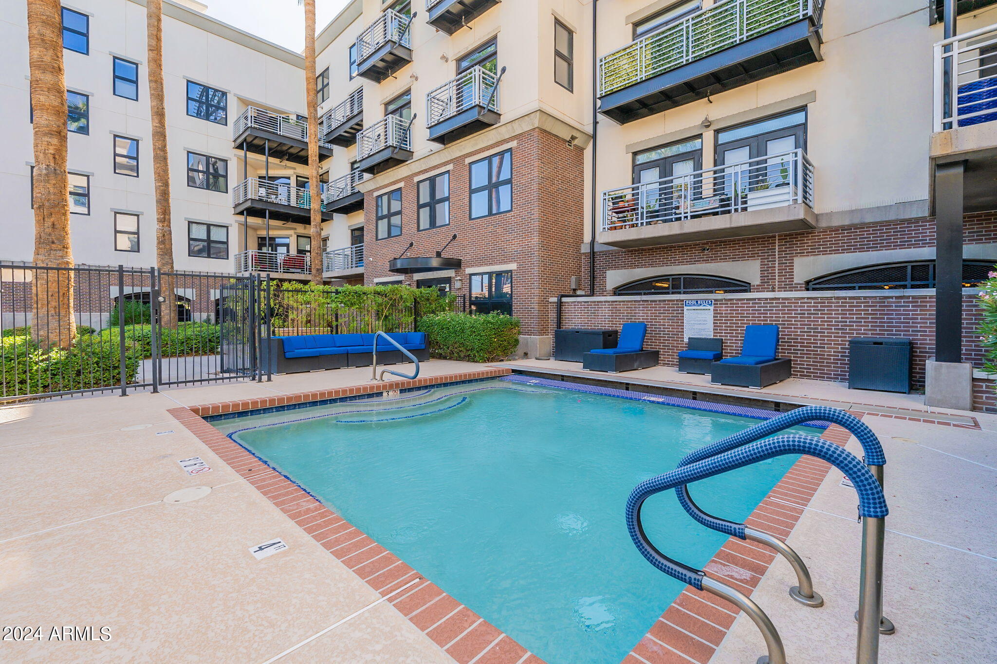 914 East Osborn Road, Unit 416 Phoenix, AZ 85014 - Photo 41 of 44 a view of a swimming pool with a lounge chairs