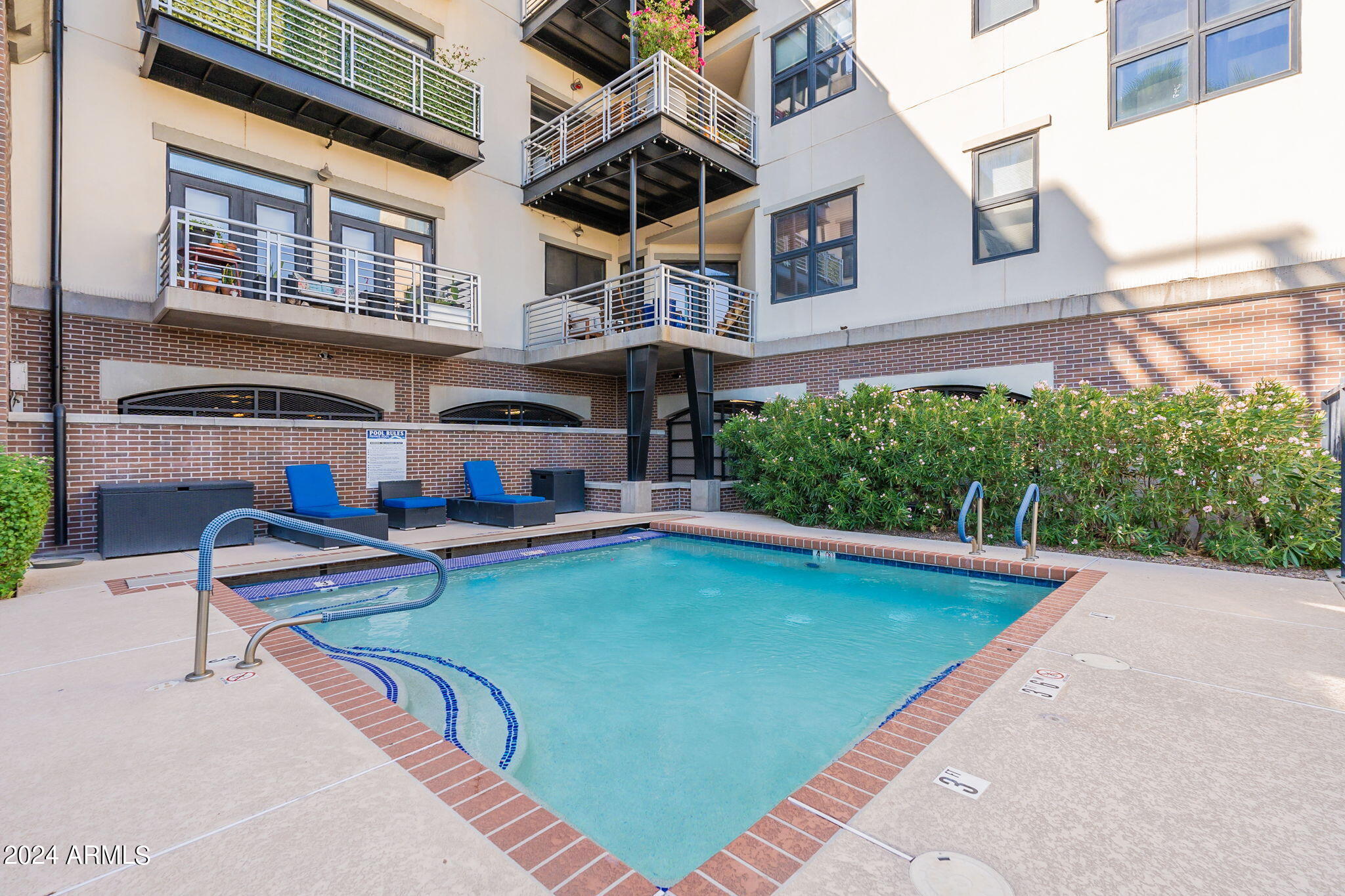 914 East Osborn Road, Unit 416 Phoenix, AZ 85014 - Photo 42 of 44 a view of a swimming pool with a lounge chairs