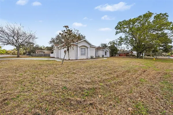 a big house with a big yard and large trees