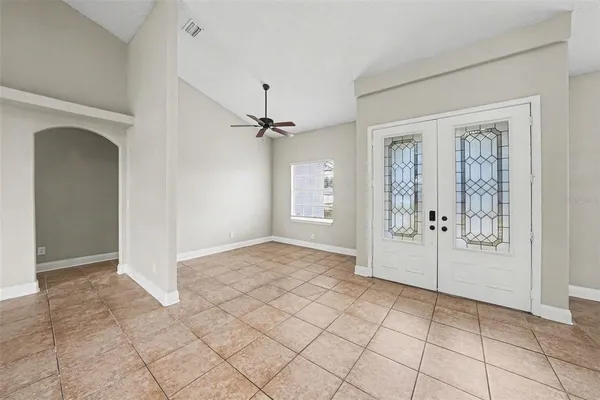 an empty room with windows and closet