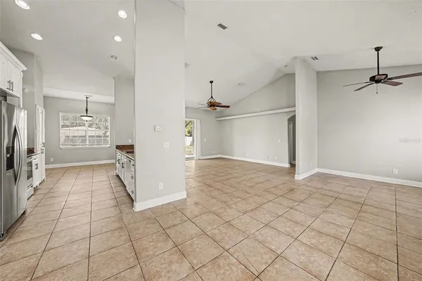 a view of a kitchen with a sink and refrigerator