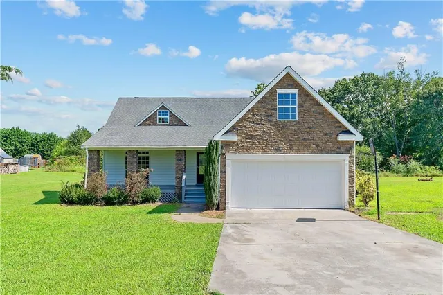 a front view of house with yard and green space