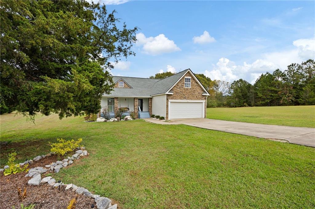 7 Herchel Mize Road Southwest Cave Spring, GA 30124 - Photo 18 of 58 a front view of a house with garden