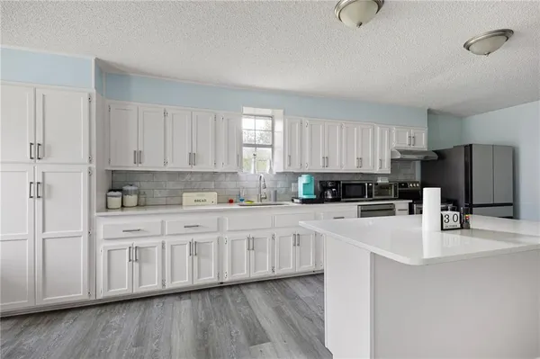 a kitchen with a refrigerator and a wooden cabinets