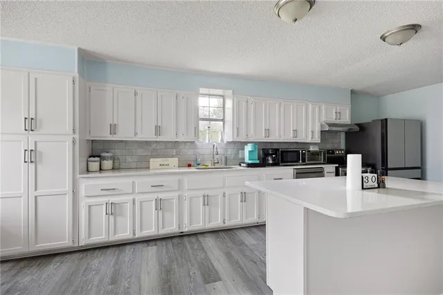 a kitchen with a refrigerator and a wooden cabinets
