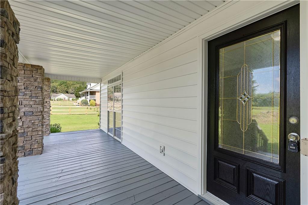 7 Herchel Mize Road Southwest Cave Spring, GA 30124 - Photo 3 of 58 a view of a porch with wooden floor and a brick wall