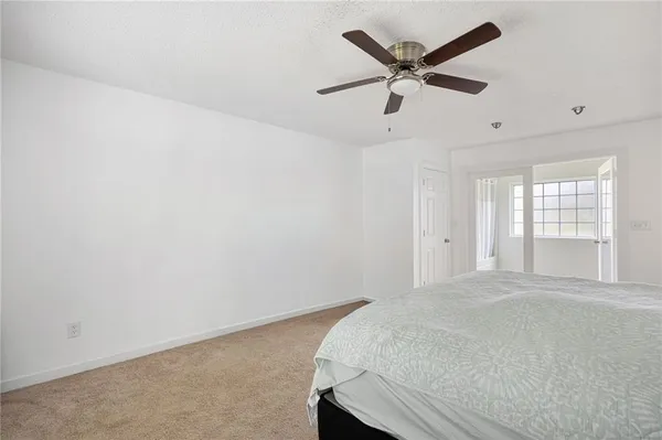 an empty room with windows and closet