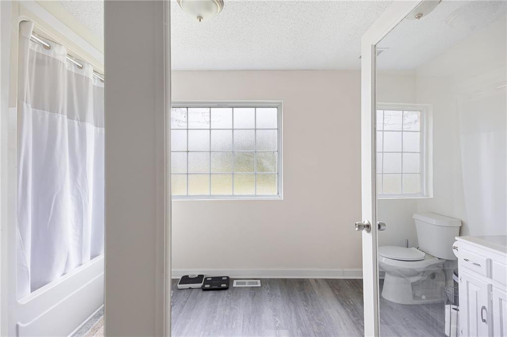 7 Herchel Mize Road Southwest Cave Spring, GA 30124 - Photo 37 of 58 a bathroom with a toilet a sink and a window