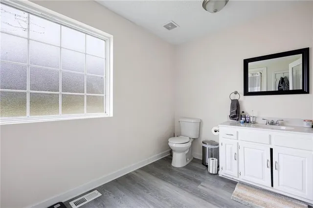 a room with a bed a chair and a chandelier