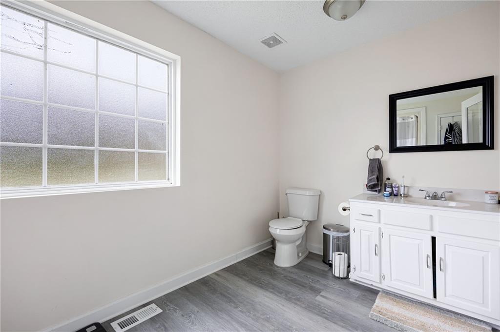 7 Herchel Mize Road Southwest Cave Spring, GA 30124 - Photo 38 of 58 a bathroom with a toilet a sink a vanity and window