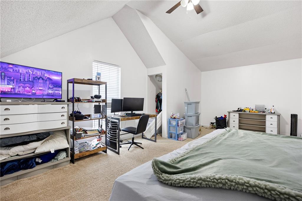 7 Herchel Mize Road Southwest Cave Spring, GA 30124 - Photo 45 of 58 a room with a bed a chair and a chandelier