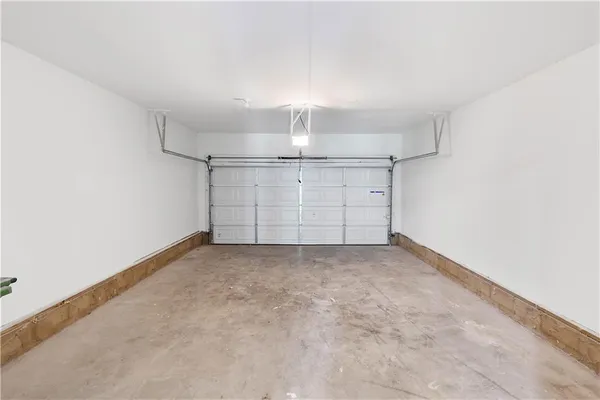 an empty room with chandelier fan