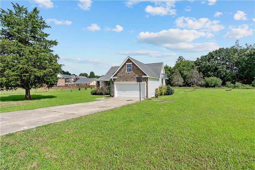 7 Herchel Mize Road Southwest Cave Spring, GA 30124 - Photo 8 of 58 a view of a house with a big yard plants and large trees