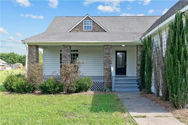 a front view of a house with garden