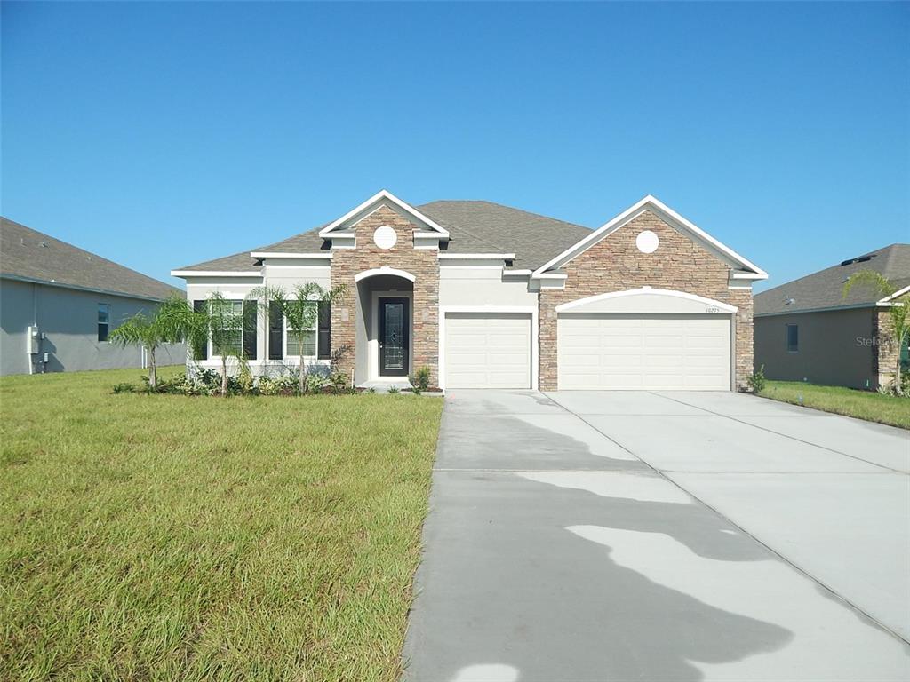 10275 Harmony Ridge Way Clermont, FL 34711 - Photo 1 of 1 a front view of a house with a yard and garage