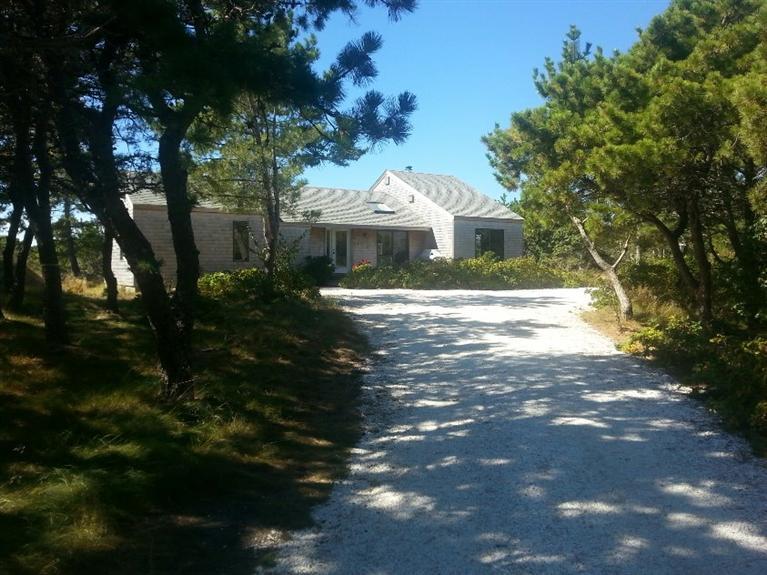 10 Turnstone Road Truro, MA 02666 - Photo 1 of 29 a front view of a house with a yard and garage
