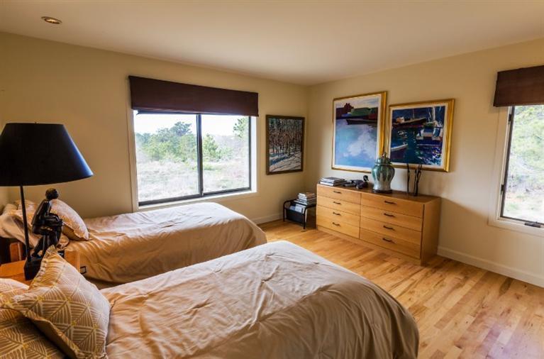 10 Turnstone Road Truro, MA 02666 - Photo 27 of 29 a bedroom with a bed and wooden floor