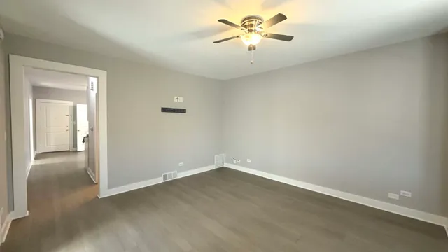 an empty room with a view of a kitchen