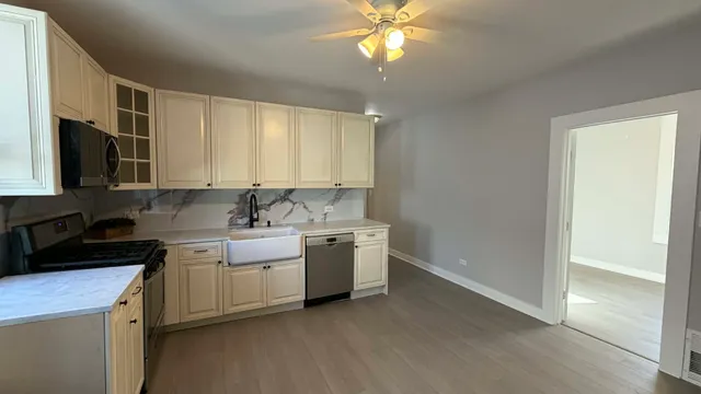 a kitchen with a sink cabinets and window