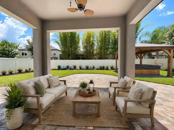 a view of swimming pool with seating area and furniture