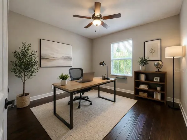 a living room with furniture a window and a potted plant
