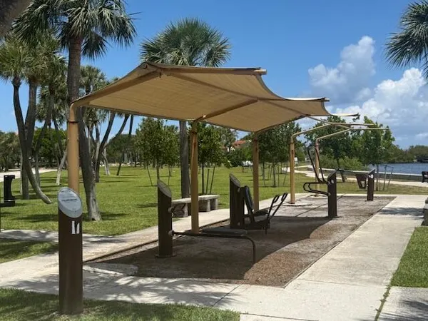 a view of a park with iron fence
