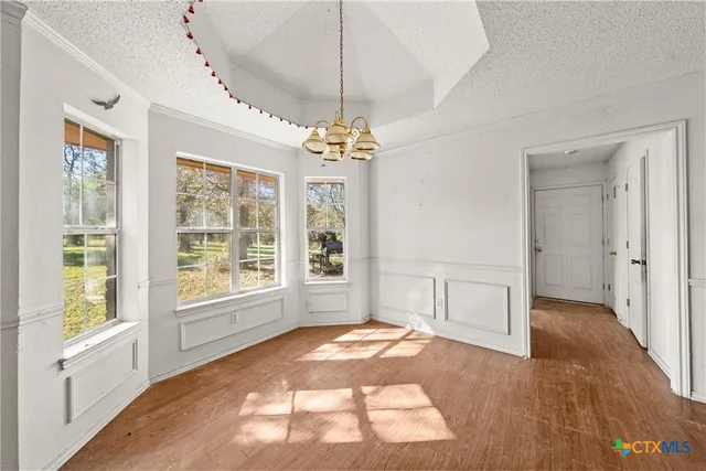 a kitchen with granite countertop a stove top oven sink and cabinets
