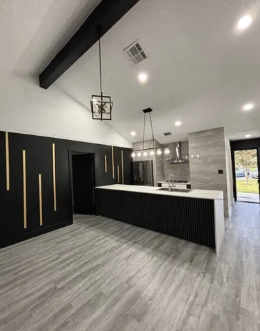 a large kitchen with stainless steel appliances kitchen island a large island in the center