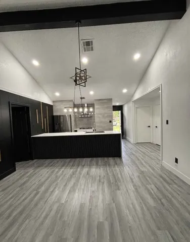 a view of kitchen with refrigerator and window
