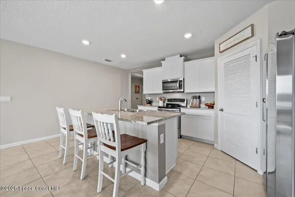 a kitchen with stainless steel appliances granite countertop a sink and cabinets