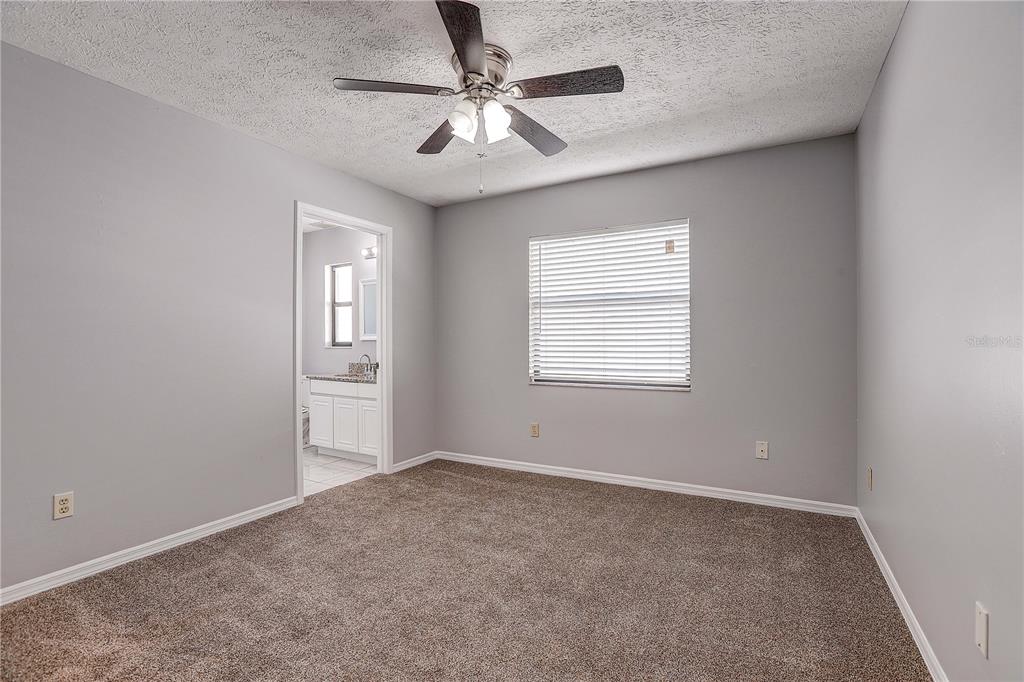1418 Buckner Road Valrico, FL 33596 - Photo 25 of 37 an empty room with windows and fan