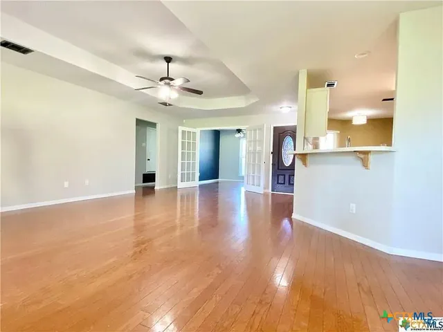 wooden floor in an empty room with a window