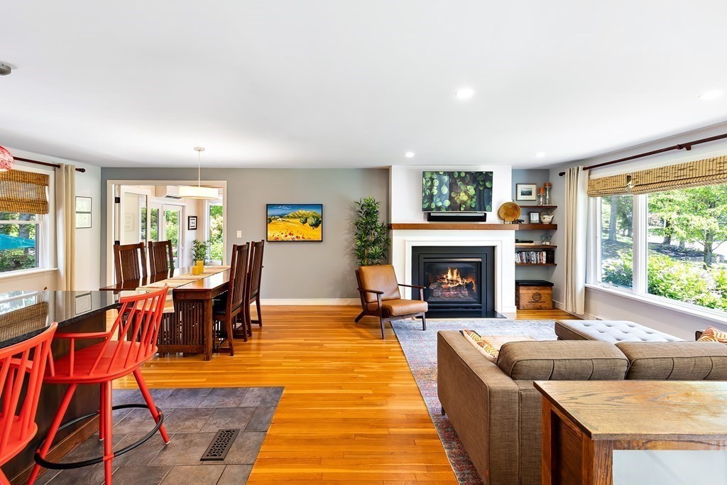 31 Tall Tree Road Sharon, MA 02067 - Photo 4 of 24 a living room with furniture a flat screen tv and a fireplace