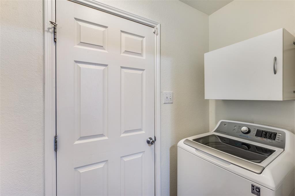 1012 Barbara Street Denton, TX 76209 - Photo 18 of 23 a view of storage and utility room with washer and dryer