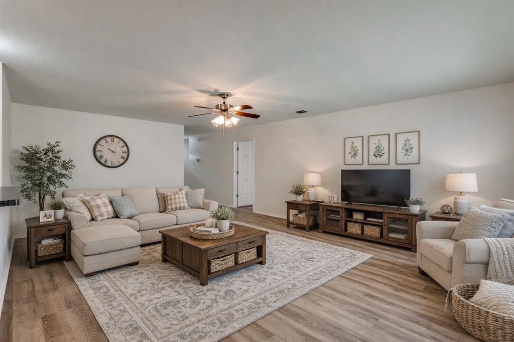 1012 Barbara Street Denton, TX 76209 - Photo 2 of 23 a living room with furniture and a flat screen tv