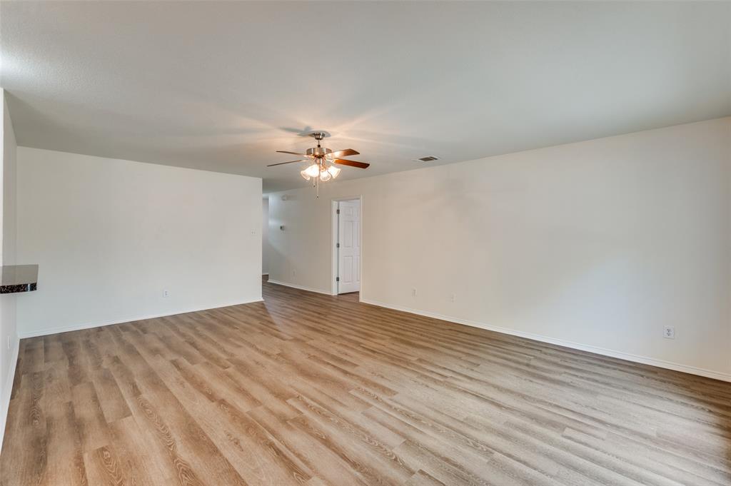 1012 Barbara Street Denton, TX 76209 - Photo 3 of 23 a view of an empty room with wooden floor