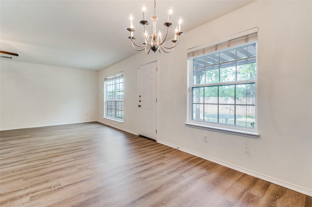 1012 Barbara Street Denton, TX 76209 - Photo 6 of 23 wooden floor in an empty room with a window