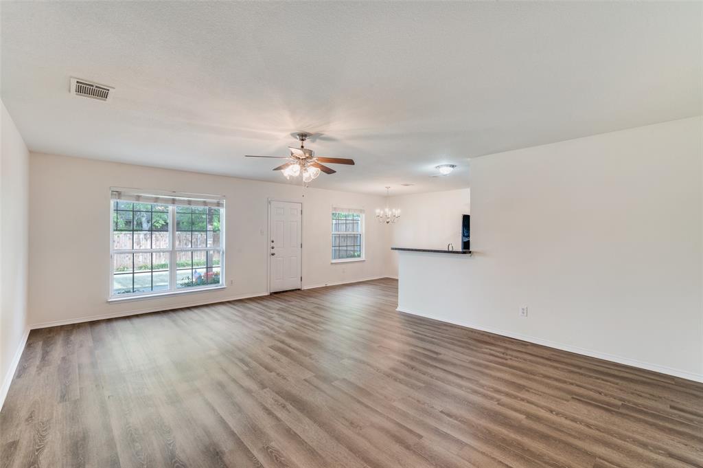 1012 Barbara Street Denton, TX 76209 - Photo 9 of 23 a view of an empty room with wooden floor and a window