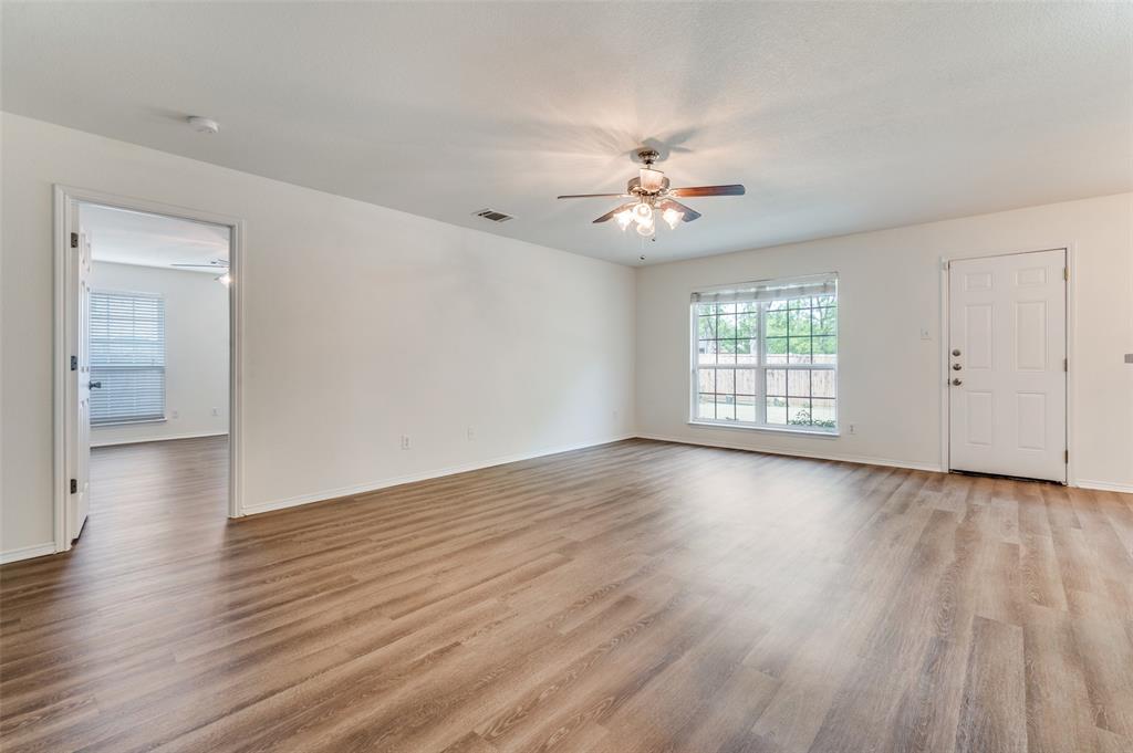 1012 Barbara Street Denton, TX 76209 - Photo 10 of 23 an empty room with wooden floor and window