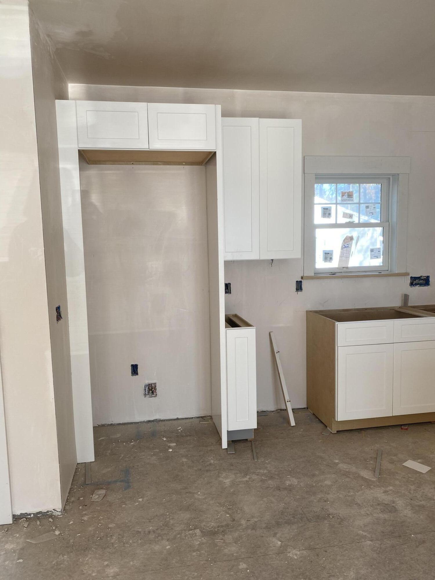 33 Running Light Way Mashpee, MA 02649 - Photo 5 of 11 a view of a kitchen with white cabinets and wooden floor