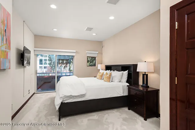 a bedroom with a large bed and a large window