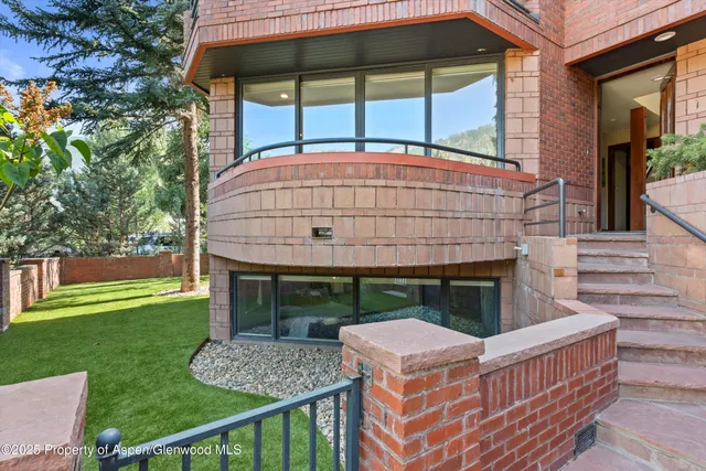 a view of house with backyard and a garden