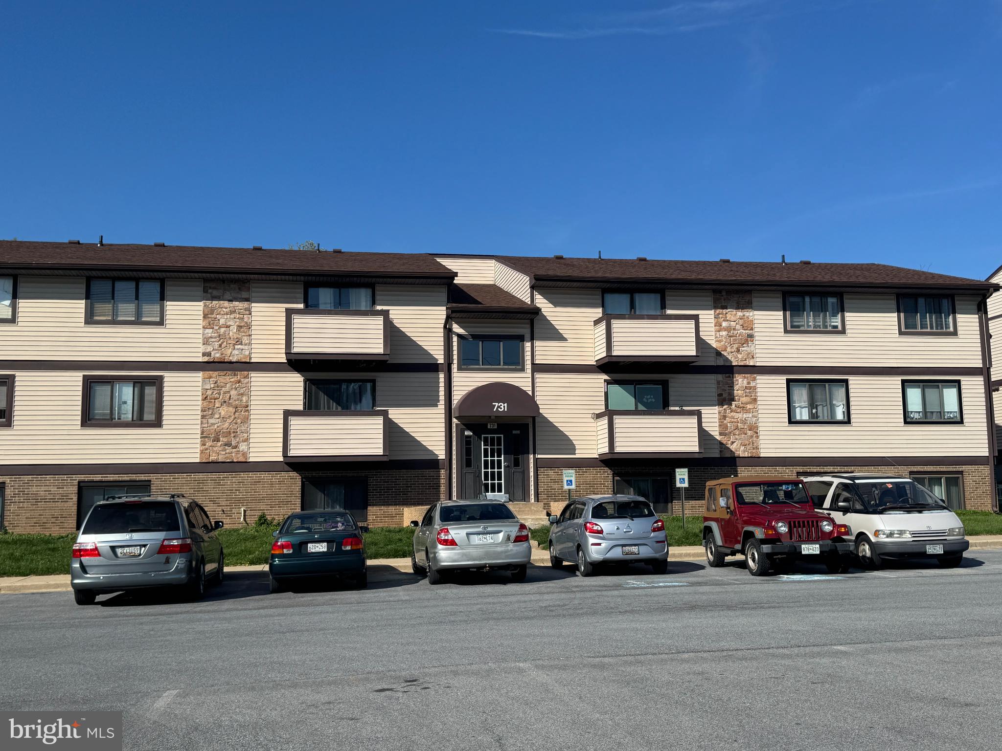 a view of a car is parked in front of a building